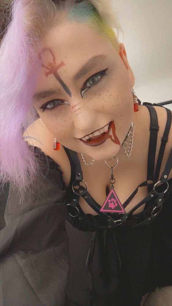 Same thing as last photo, she’s just leaning forward and flashing a fangy grin at the camera