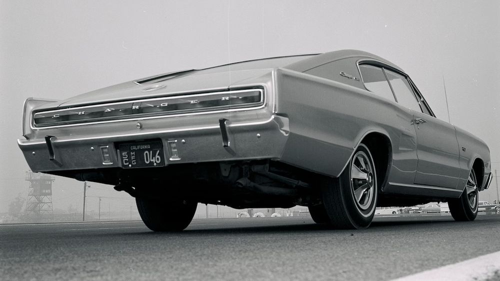 A black and white picture of a 1966 Dodge Charger, featuring a continuous rectangular taillight.