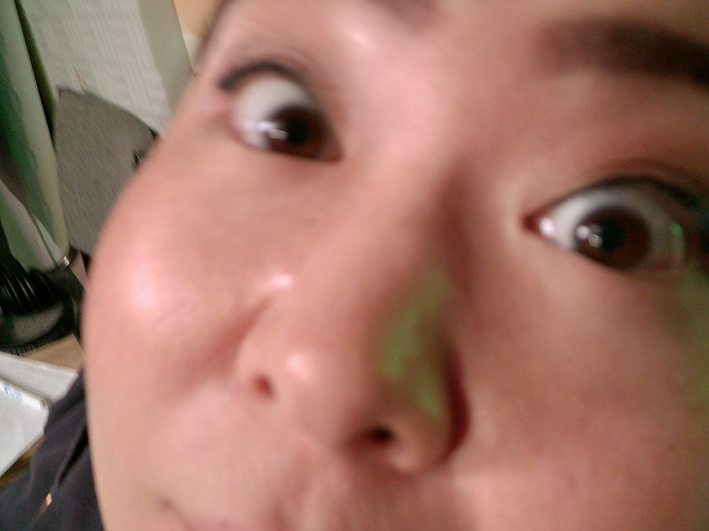 An extremely close up shot of Producer & Director Hiroka. You can Only see her eyes, nose, the corner of her mouth, and inside edge of her eyebrows. 