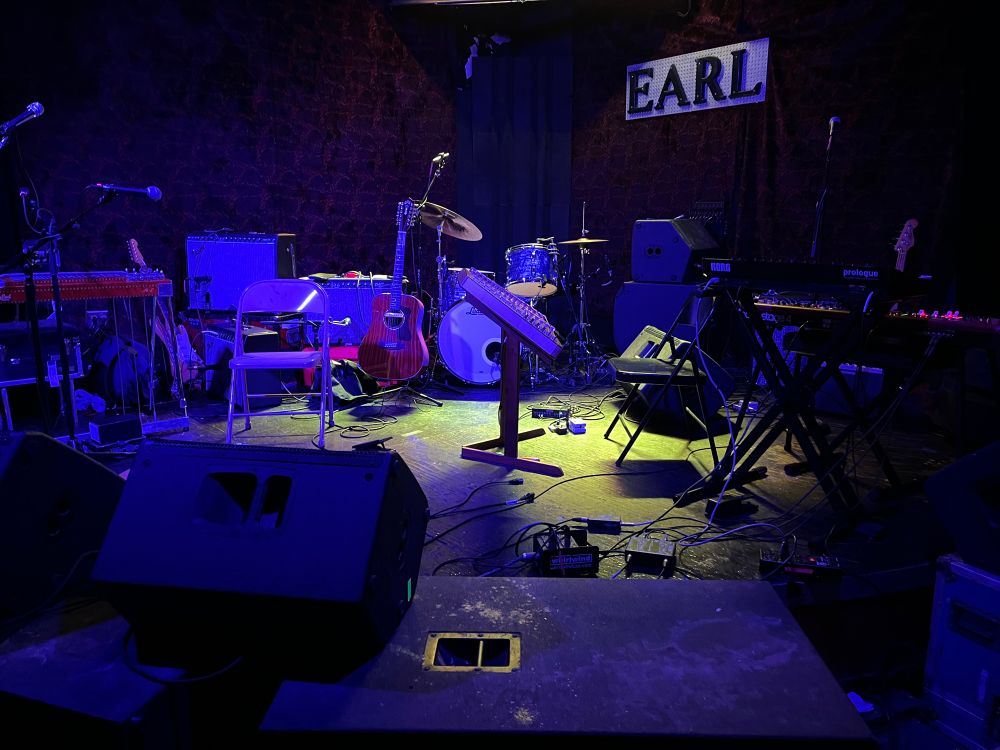 The stage at the Earl, instruments ready, purple and gold lights