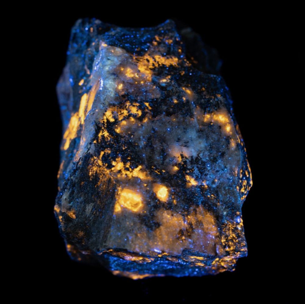 Pegmatite is a type of igneus rock that frequently contains large crystals of quartz, feldspar, or mica. When looked at with a longwave UV flashlight, these minerals seem to glow! Kids at our museum can see this for themselves up close and personal.