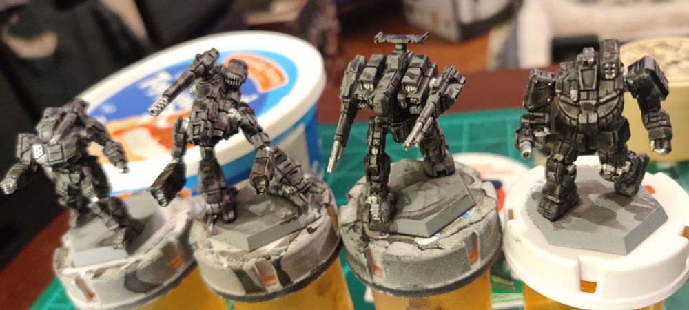 BattleTech miniatures. Left to right: Shadowhawk, Marauder, Rifleman, Wolverine.