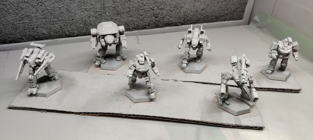 BattleTech minis, freshly primed. From left to right: Rifleman, Dire Wolf, Shadowhawk, Archer, Marauder, Wolverine.