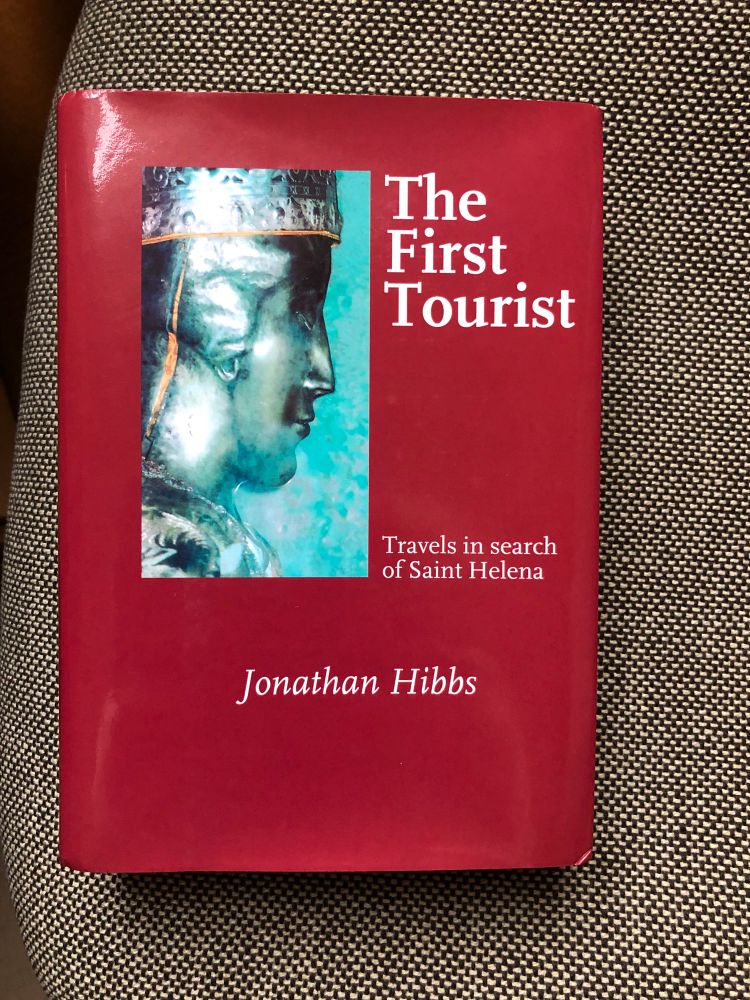Cover of Jonathan Hibbs, The first tourist, Chippenham 2005. cover image of a silver reliquary in the shape of a female head, in silhouette, from Sant‘Elena, Venice