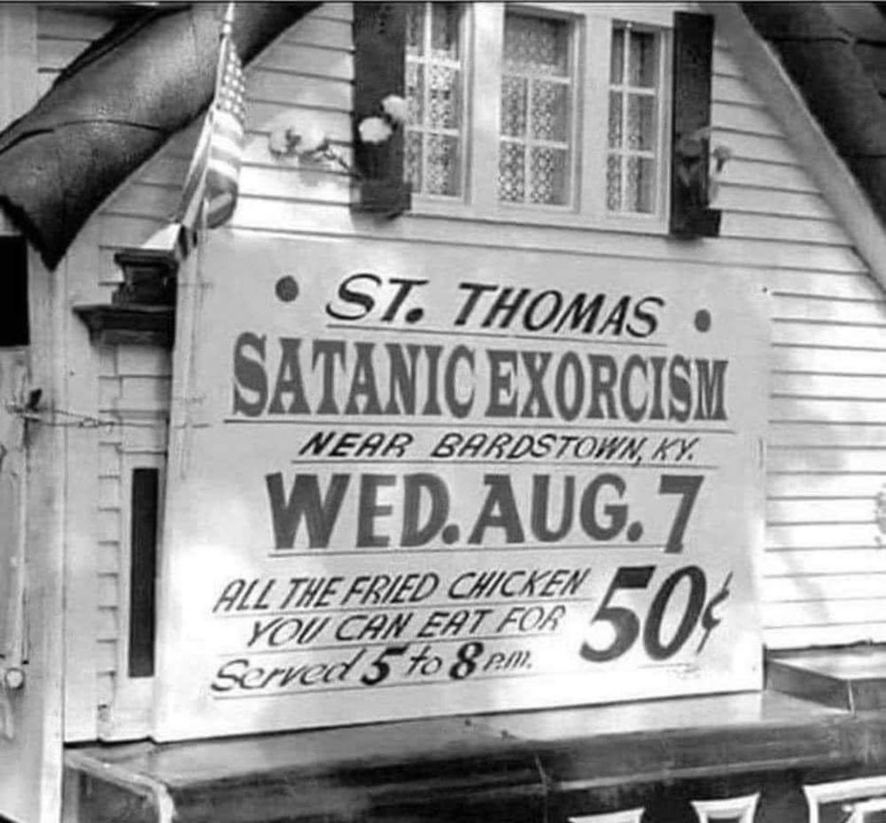 Historical photo of a sign on a barn that reads “St. Thomas satanic exorcism near Bardstown, KY Wednesday August 7. All the fried chicken you can eat for .50 cents served 5 to 8pm.