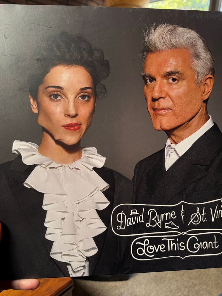 album cover of Love This Giant: annie clark wearing surreal face prosthetics next to david byrne