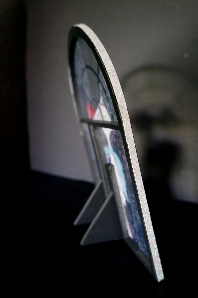 Same standee, side and back view, the side has a stripe of holographic glitter paper, the structure is made out of foamboard