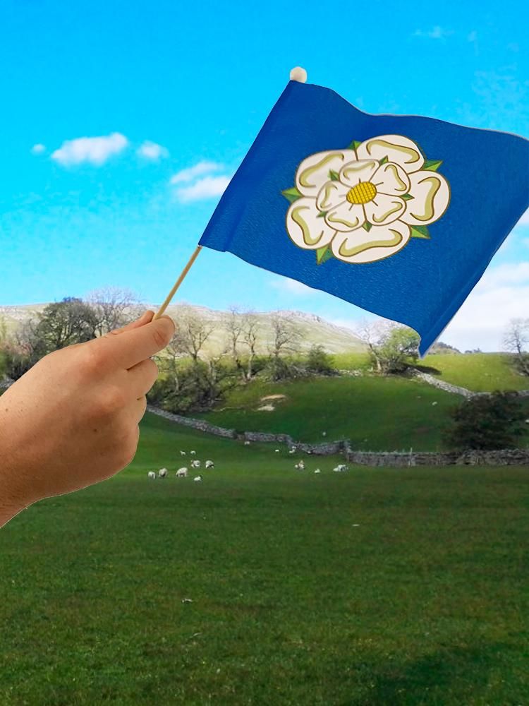 A hand holding a Yorkshire flag 