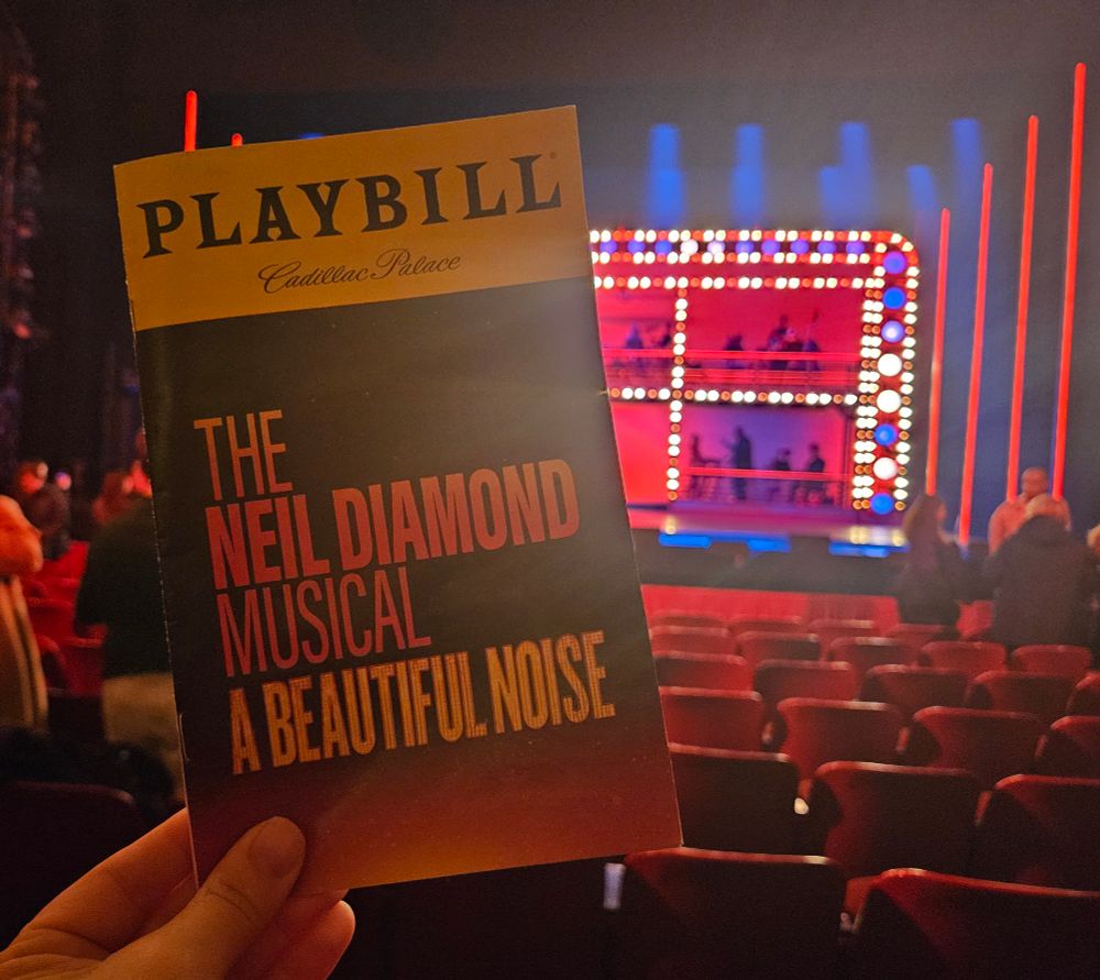 Program to A Beautiful Noise in front of a very lit stage.