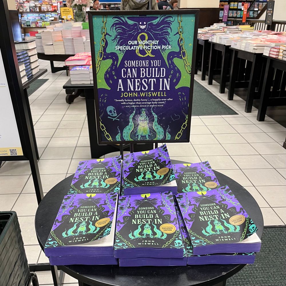 A display of Someone to Build a Nest In showing it as the monthly speculative fiction pick.
