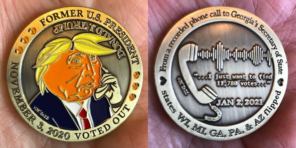 Two sides of a coin.

First side has Trump on the phone, his orange face looking like a Georgia peach, with leaves as his hair. The text reads: "Former U.S. President Donald J. Trump November 3, 2020 Voted Out"

The other side has the etched image of a phone with sound waves coming out of it and the quote " ... I just want to find 11,730 votes ... " The text around the rim reads: "From a recorded phone call to Georgi's Secretary of State" and "states flipped WI, MI, GA, PA & AZ."