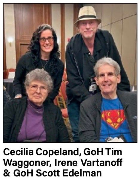 Cecilia Copeland and Tim Waggoner standing behind Irene Vartanoff and me, who are seated. I'm wearing a blue T-shirt with a red-and-yellow chest symbol which combines the Superman S and and outline of Cthulhu.
