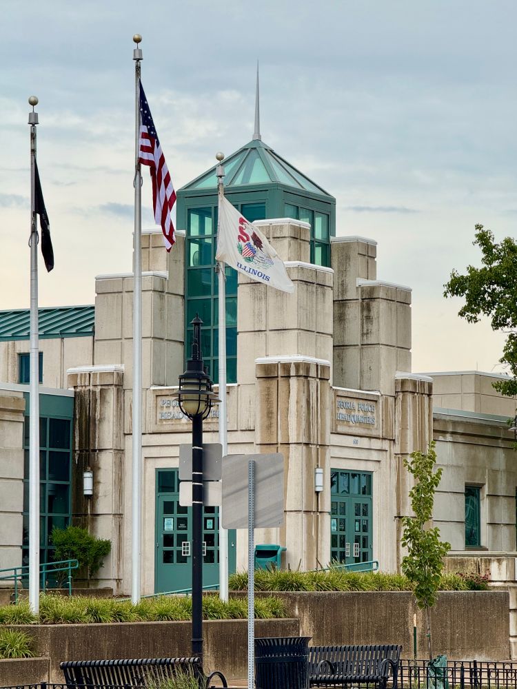 Postmodern art deco revival fortress with green tower and doors 