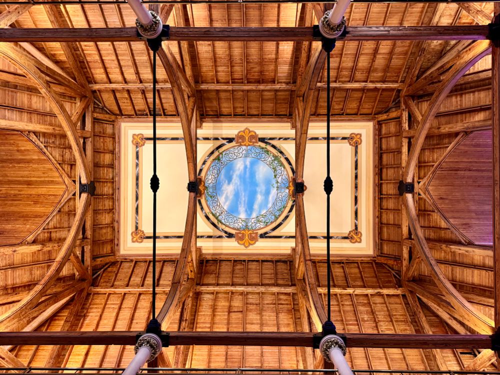 A view of the ceiling with a former skylight that has been painted to look like a window. 