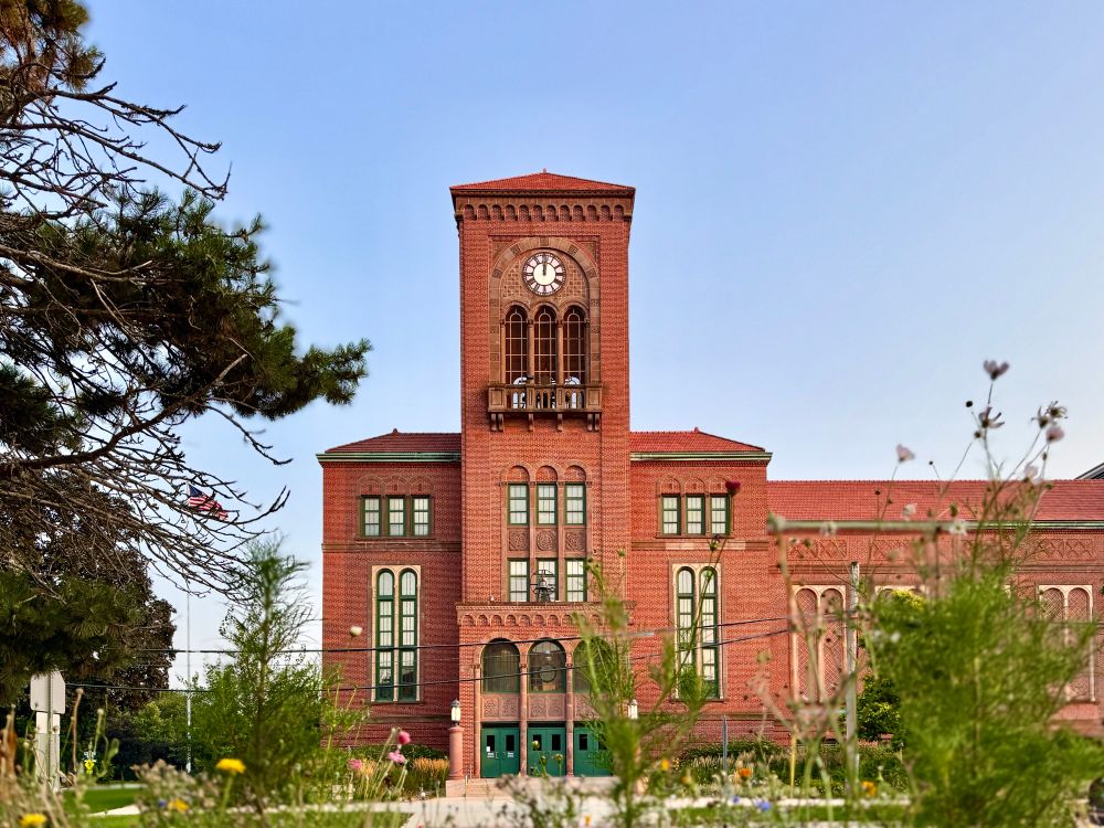 More of the building with arched entrance and arched windows and red tile roof