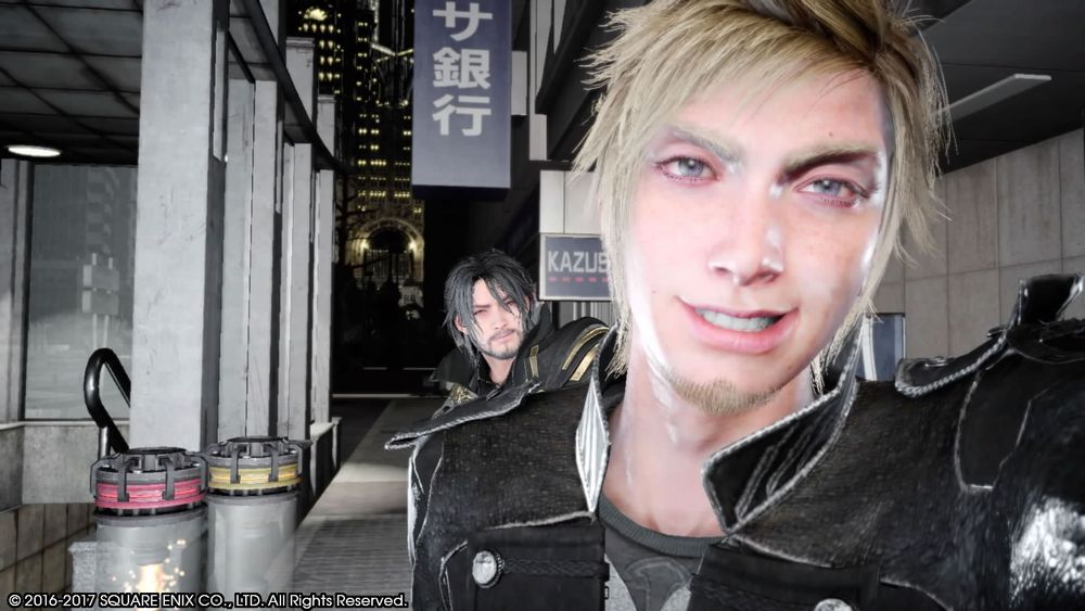 A screenshot from Final Fantasy XV. Prompto is taking a selfie; Noctis is peeking out from behind him.