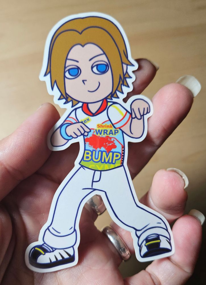 A sticker of Lion Rafale from Virtua Fighter in his very 90s outfit from VF3. He's illustrated in the Pop'n Music style. He fits in my hand!