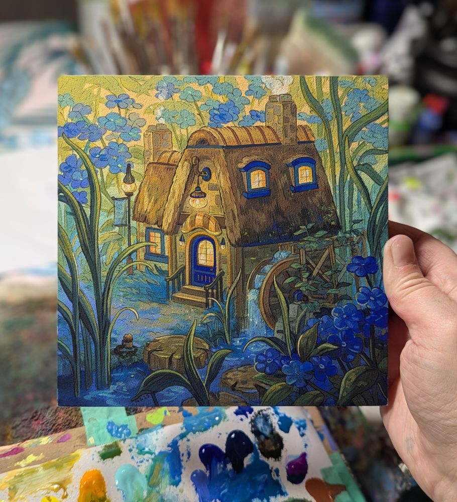 Artist holding painting featuring a watermill surrounded by blue flowers and water 