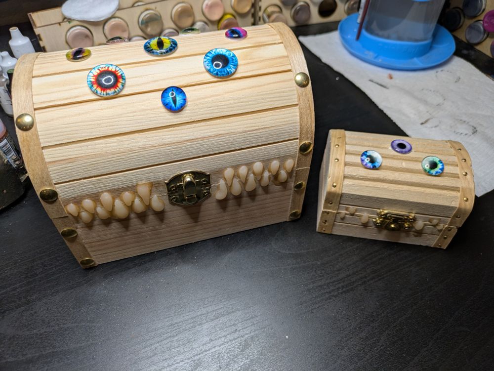 Glass eyes and false teeth glued onto 2 undecorated trinket boxes