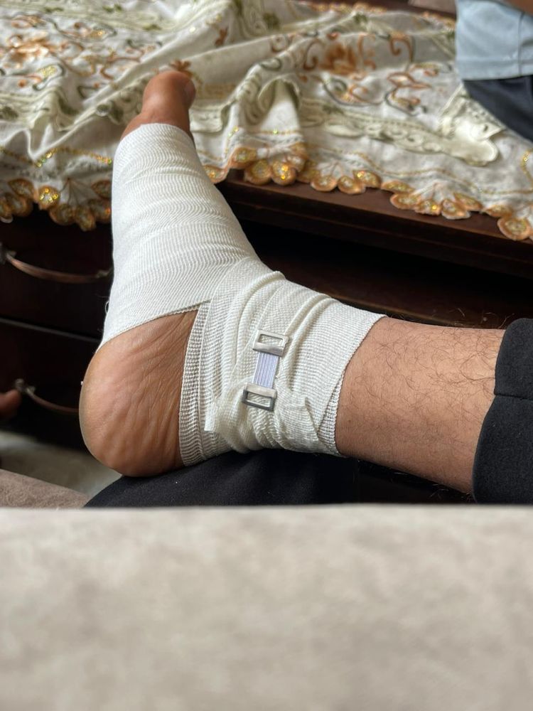 A foot wrapped in an ace bandage.