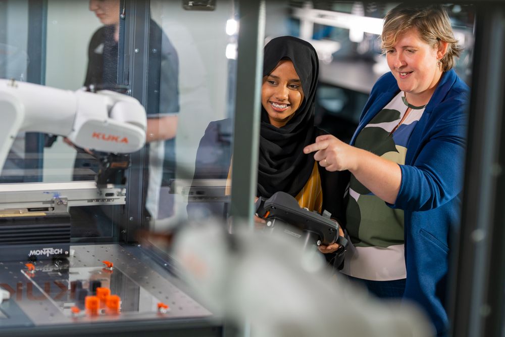 
a faculty member instructing a student in a robotics engineering lab at Ontario tech