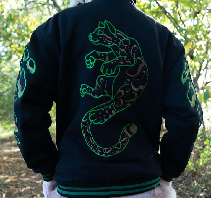 A varsity jacket with a green clouded leopard embroidered on the back