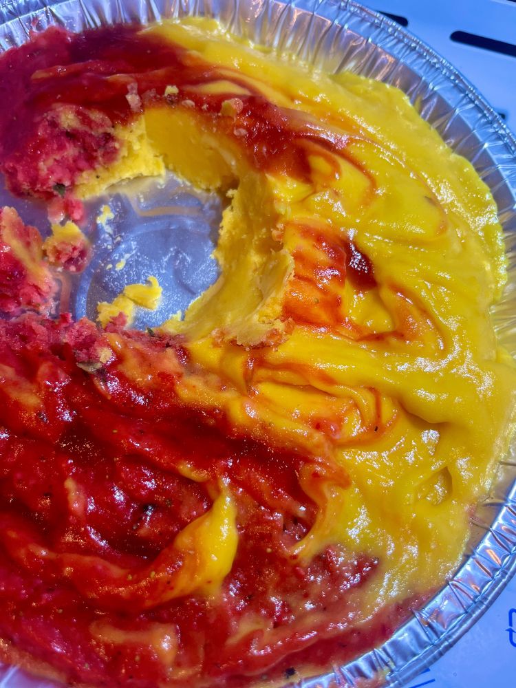 Homemade mango and strawberry sorbet swirled with chamoy appears in a tin 