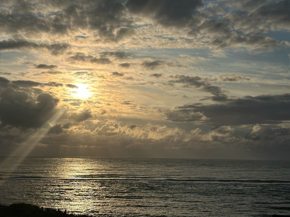 Shafts of sunlight through a cloudy sky