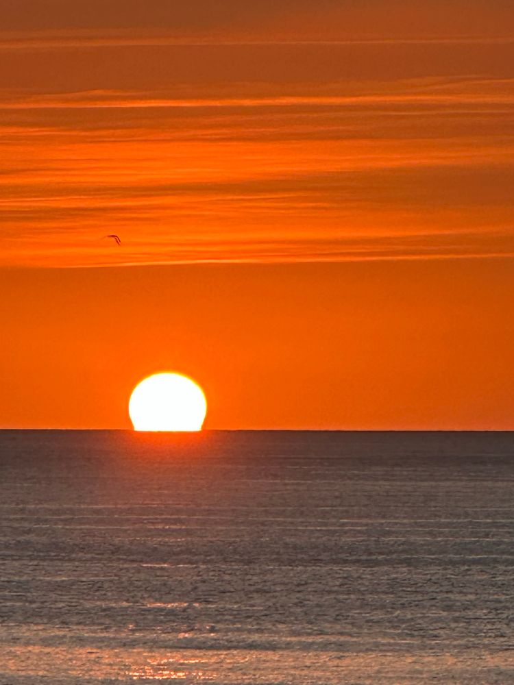 Orange glow, flat sea