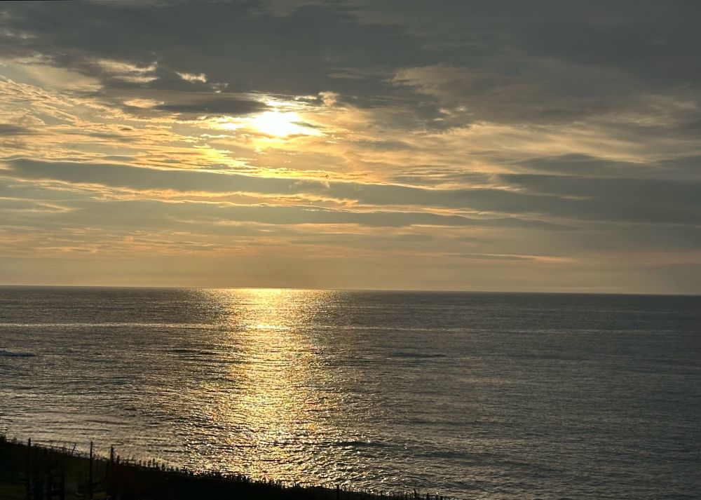 golden reflections on a flat sea