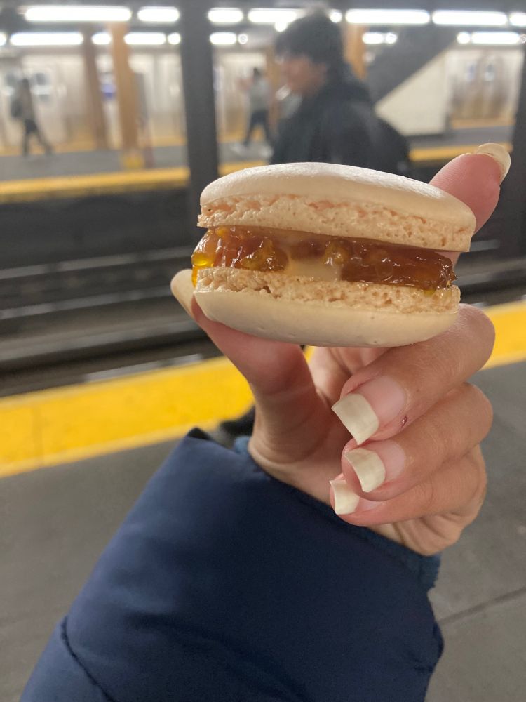 Plump saffron marmalade macaron with swirl of lemon curd