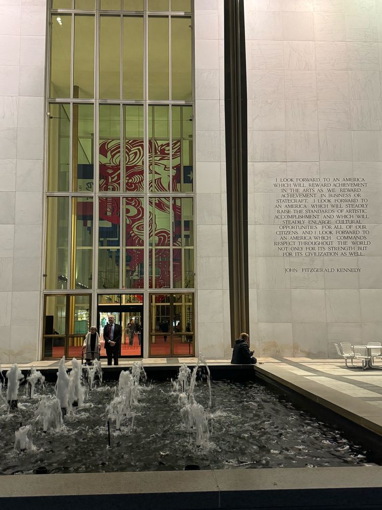 Photo showing quote in prior post to right of huge, multi-story high window and door, with fountain in foreground