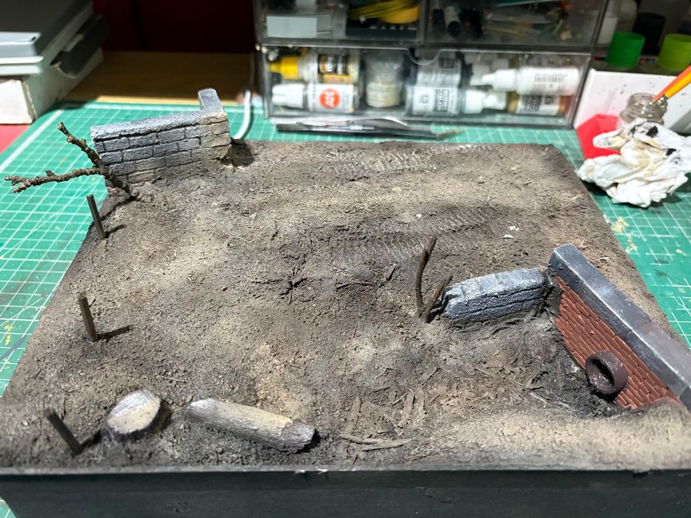 A diorama base, with texture and painted with an airbrush in various earth tones. Ready for the next stage, grass effects then snow. 