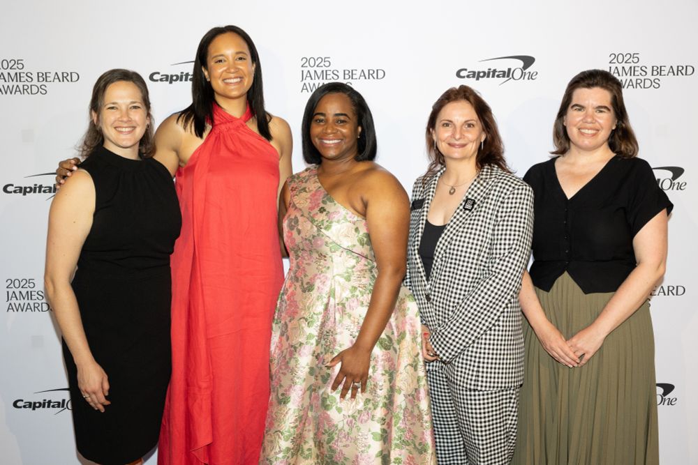 
Aspen Food Leaders Fellows (left to right) Kendra Levine, Global Restaurant Sustainability Director, McDonald's; Lindsey Allen, Environmental Sustainability Manager, Food & Supply Chain, Disney Experiences; Seanicaa Edwards Herron, Founder & Executive Director, Freedmen Heirs Foundation, Inc and James Beard Foundation Impact Award honoree; Anne McBride, Anne McBride, Vice President of Programs, James Beard Foundation; and Julia Luscombe, Vice President, Strategic Planning & Portfolio Management, Feeding America. They stand before a white black drop with black lettering that reads, 2025 James Beard Foundation Awards and the Capital One logo. 