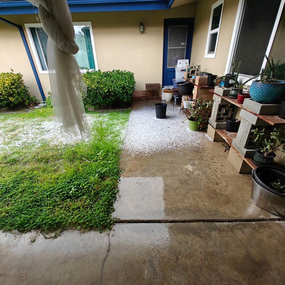 Hail pellets in the uncovered section of the patio 
