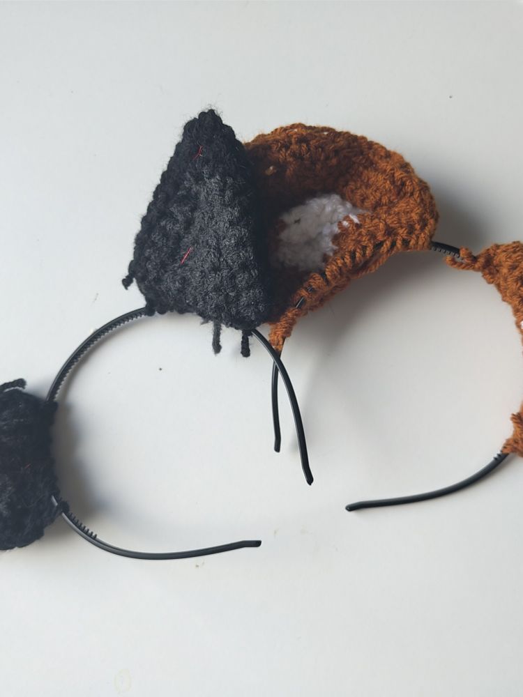 Two headbands with crocheted ears
1) black and grey cat ears
2) brown and white dog ears 