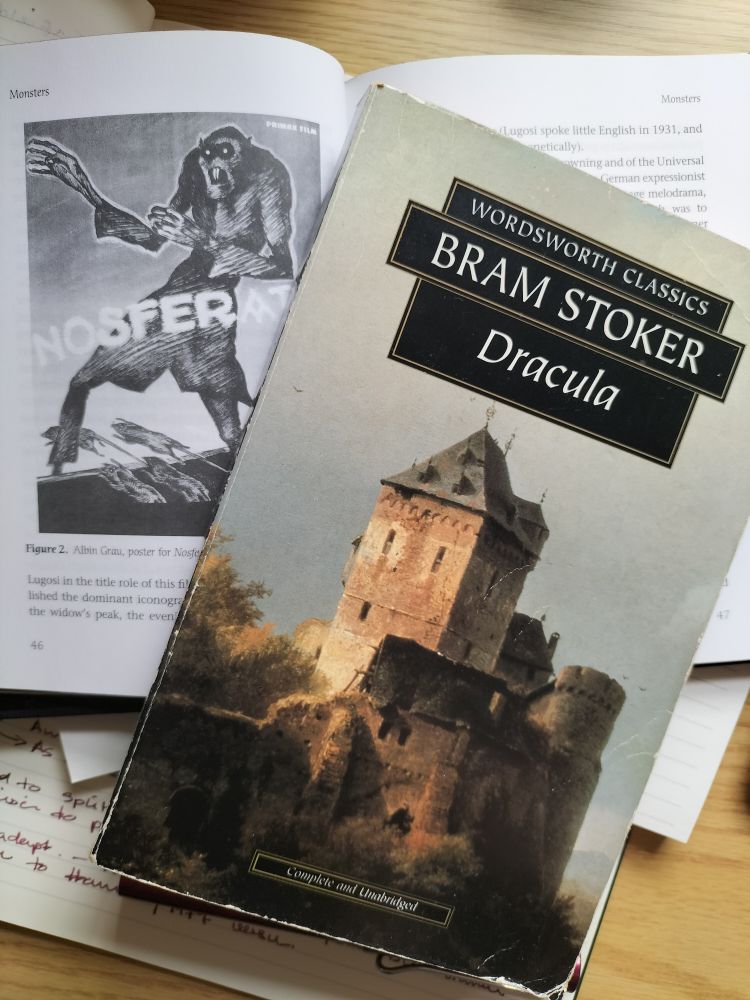 A copy of Bram Stoker's Dracula on top of an open copy of Sleeping With the Lights On