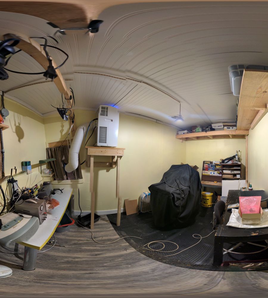 Weird panorama of print shop with the AC lifted up on shelf.