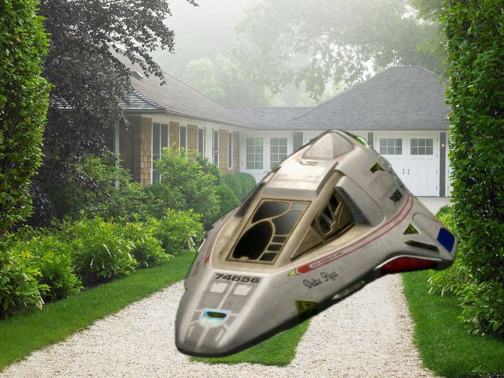 The Delta Flyer from “Star Trek: Voyager” parked in a gravel driveway in front of a house.