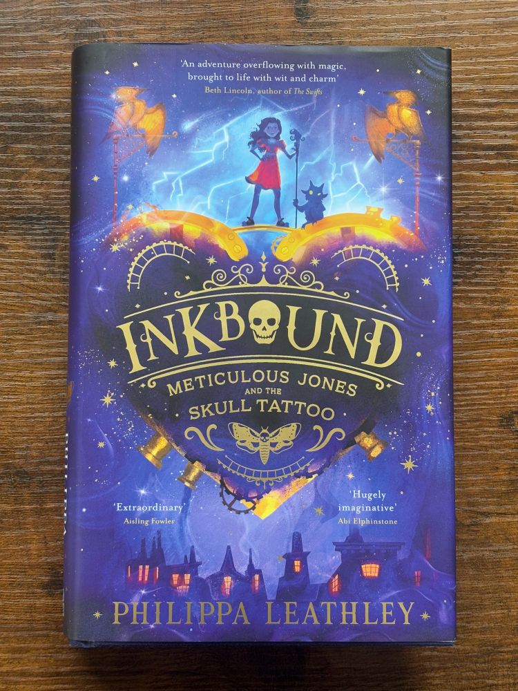 Inkbound Meticulous Jones and the Skull Tattoo, written by Philippa Leathley, illustrated by Brie Schmida and map illustration by Nicolette Caven. Copy of the hardback book. Published by Harper Collins Children's books. 
