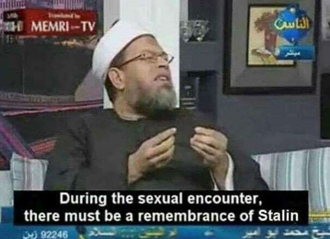 A man in black robes with a white headress speaks with expressive hands, saying "During the sexual encounter, there must be a rememberence of Stalin"