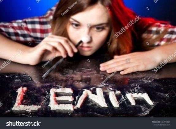 Shutterstock photo of a white brunette woman holding a straw to her nose with the word "Lenin" drawn in powder on the table in-front of her.