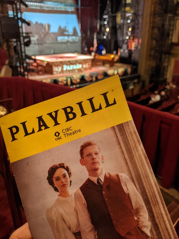 Photo of the Parade playbill with the Parade stage in the background 