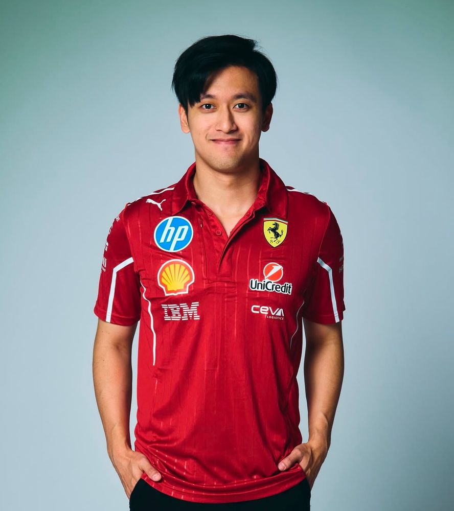 Zhou Guanyu in a 2025 ferrari top looking chuffed as