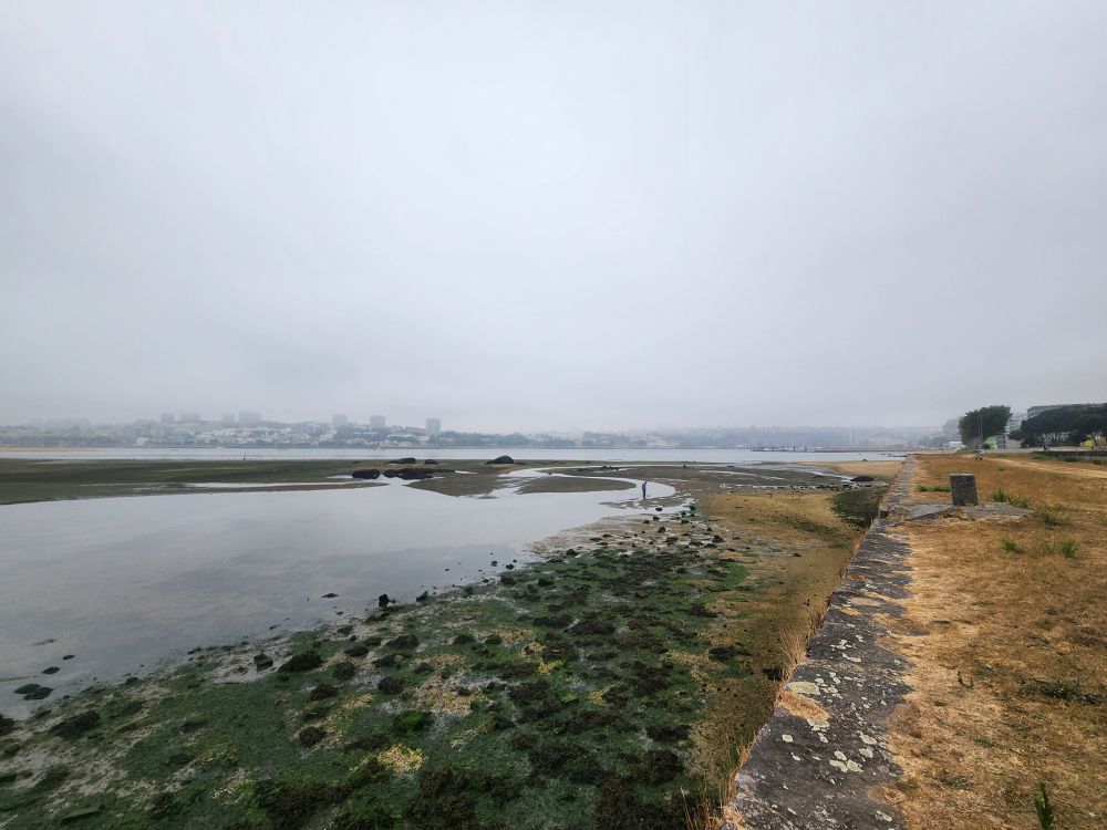Fog settles over the douro river estuary and the city of Porto. It's is finally cool after two weeks of high temperatures 