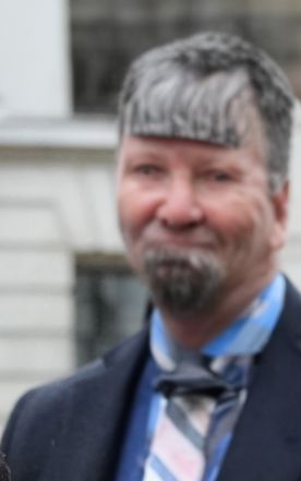 A terrible AI photograph of a man.