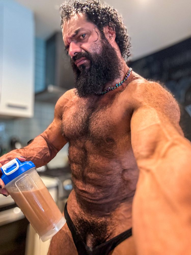 Me, holding a protein shaker and taking a selfie with my left hand