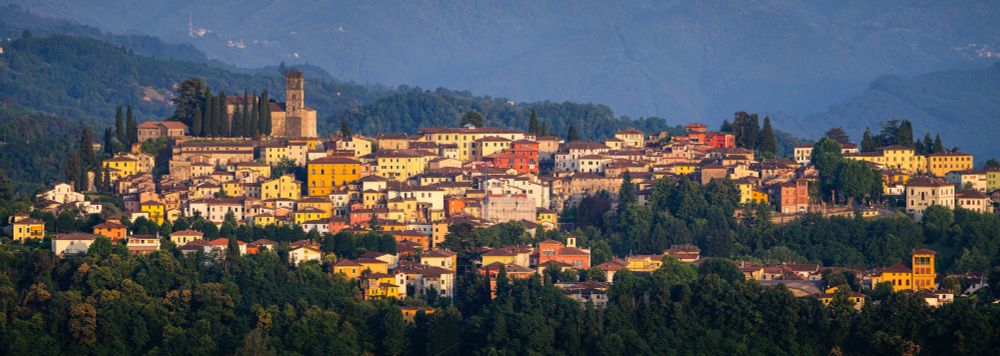 The town of Barga in Italy illuminated by the evening sun.