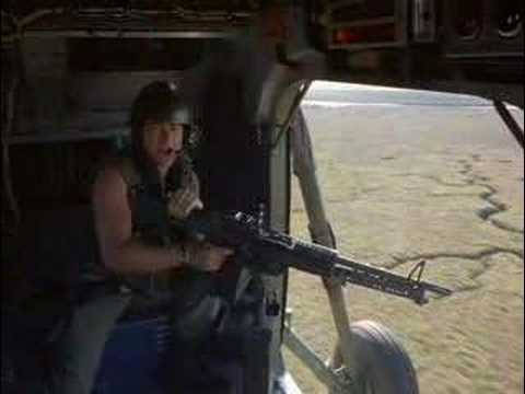 The doorgunner of a helicopter flying over fields in Vietnam from the movie Full Metal Jacket, who has just been firing his M60 machine gun indiscriminately at fleeing Vietnamese workers in the fields below.