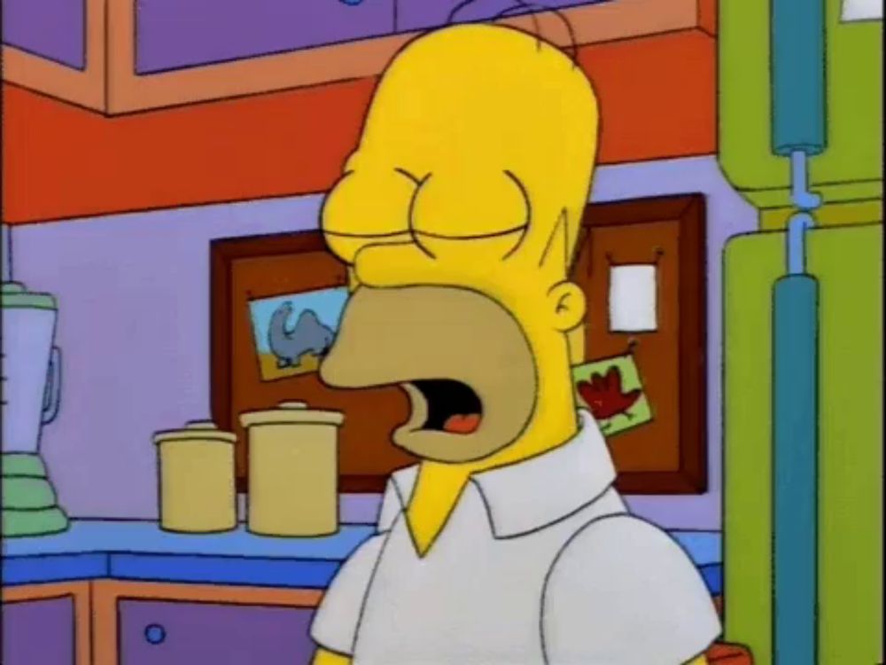 homer simpson is yawning in a kitchen with a picture of a camel on the wall behind him